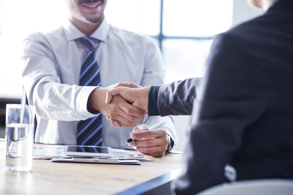 business-owner-shaking-hands-with-insurance-agent