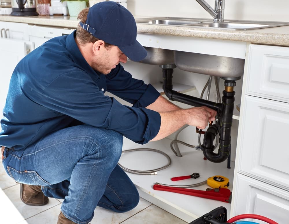 plumber-working-on-kitchen-sink