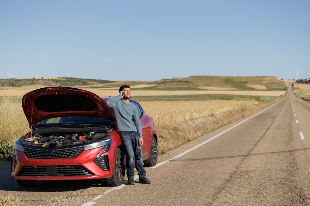 man-waiting-for-car-assistance-car-on-the-side-of-the-road 